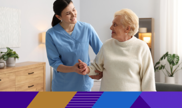carer holding hands with older lady