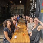 31ten women sat at table smiling