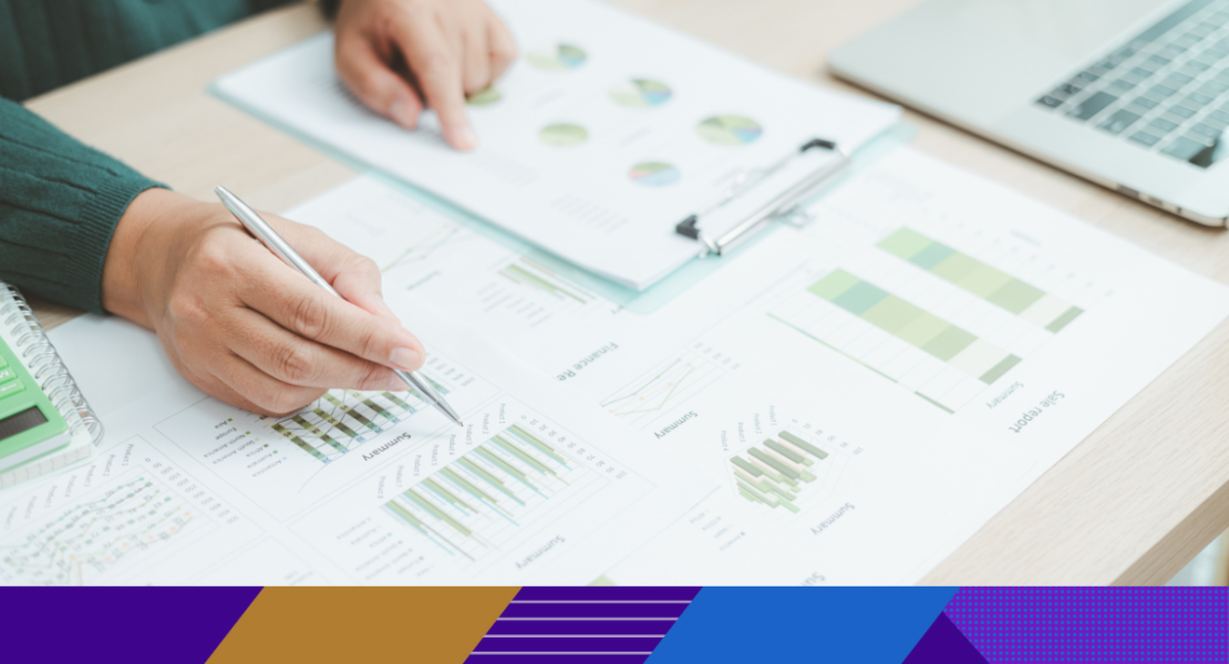 Photo of paperwork with graphs and charts