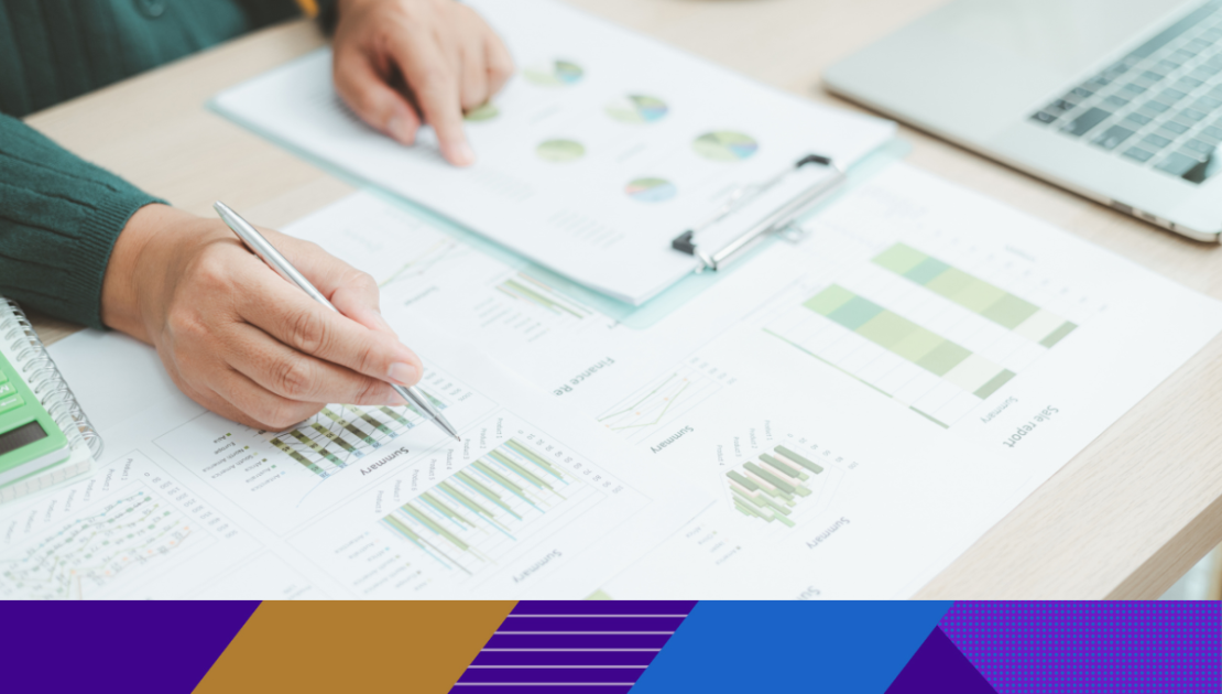 Photo of paperwork with graphs and charts