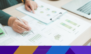 Photo of paperwork with graphs and charts