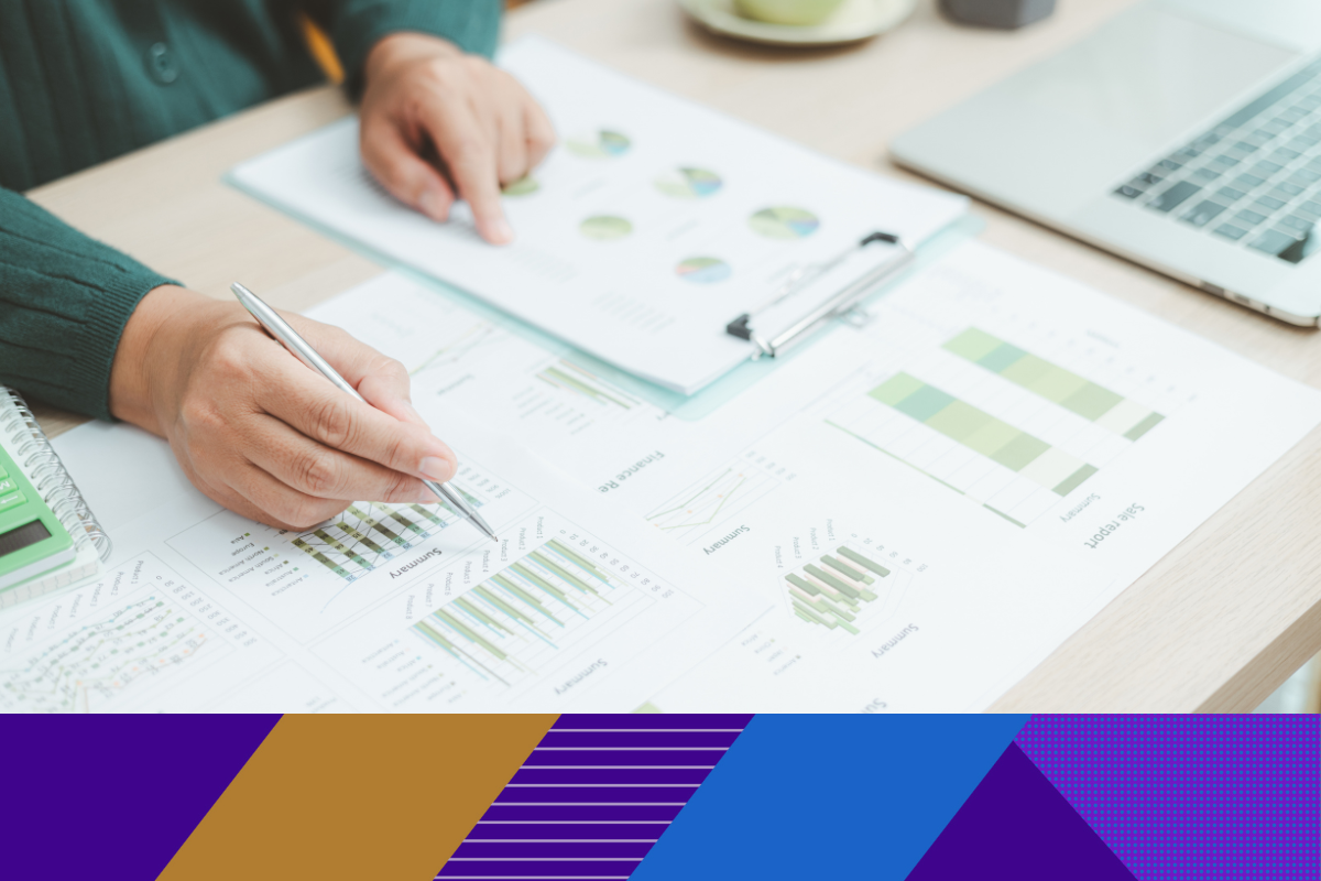 Photo of paperwork with graphs and charts